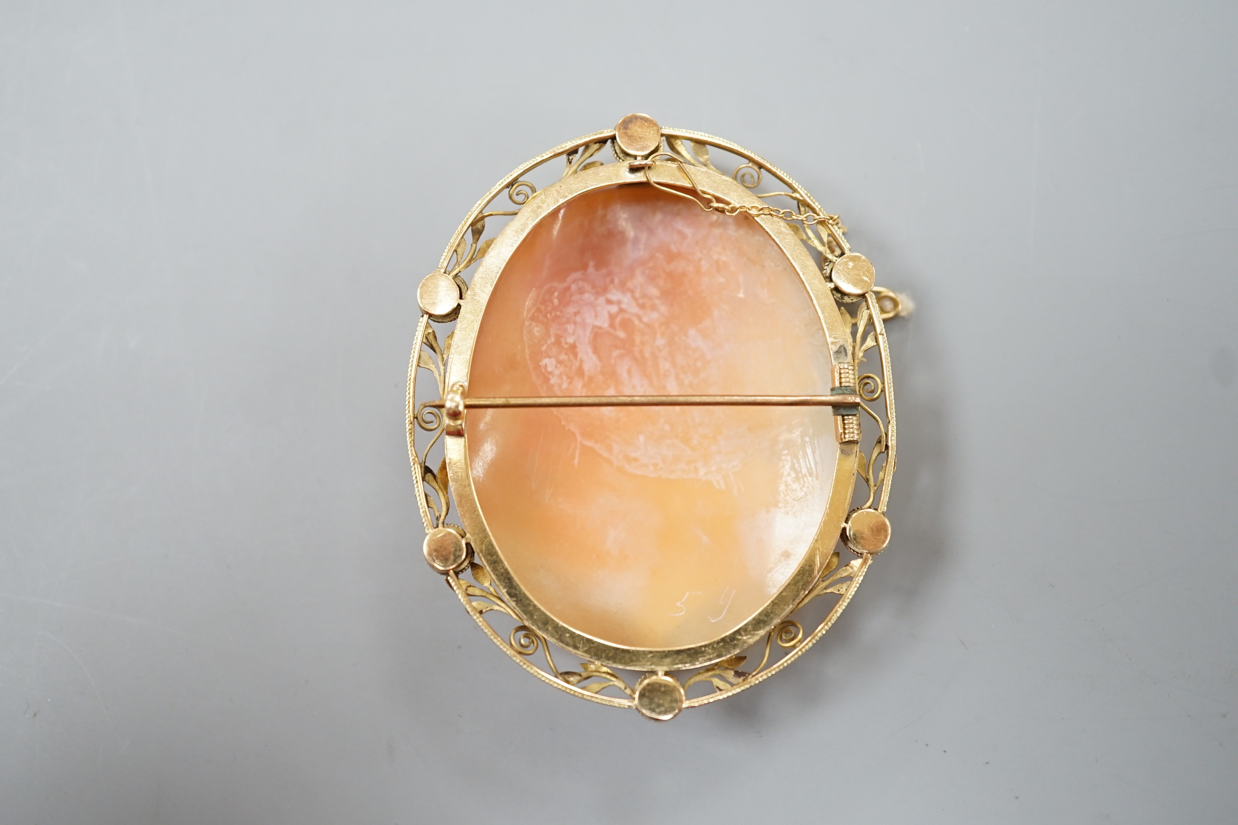 After the antique- A yellow metal mounted oval cameo shell brooch, carved with the head of a Zeus to sinister, 62mm, gross weight 20.7 grams.